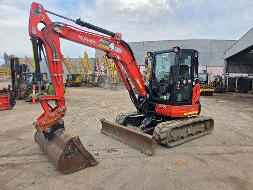 Kubota U48-4 excavator with bucket and blade at equipment yard